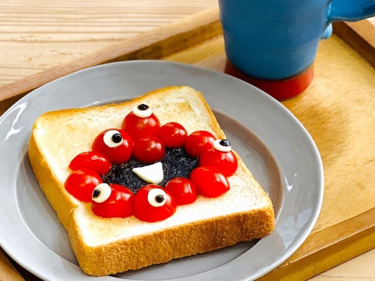 ミニトマト、海苔の佃煮、チーズで「ミャクミャク」風にデコレーションしたトースト