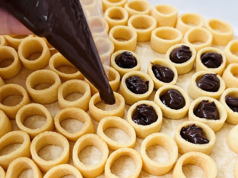 「ポテコ」の穴の中に生チョコを絞り出している様子