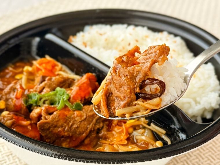 水煮牛肉 牛肉の四川風唐辛子煮込みをスプーンですくっている様子