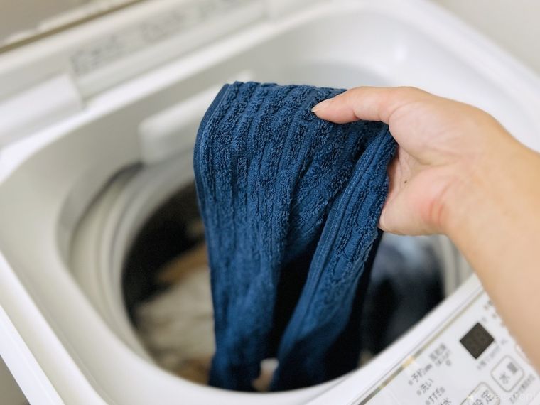 洗濯機からタオルを取り出している様子