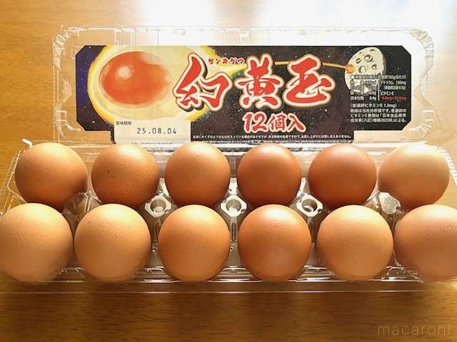 パックに入った赤い卵がテーブルに置いてある