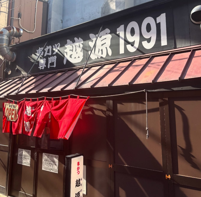 赤い暖簾がかかった串かつ 越源の外観