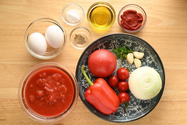 テーブルに並べられたトマトや赤パプリカ、卵などのシャクシュカの材料