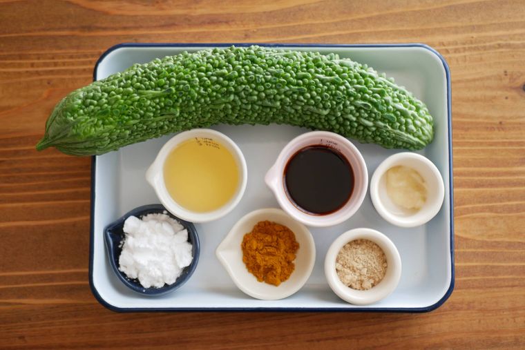 白い琺瑯バットの上にゴーヤのワタごとカレー揚げの材料が並べられている