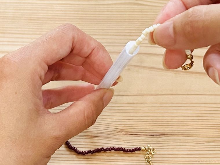 ストローにネックレスを通している様子