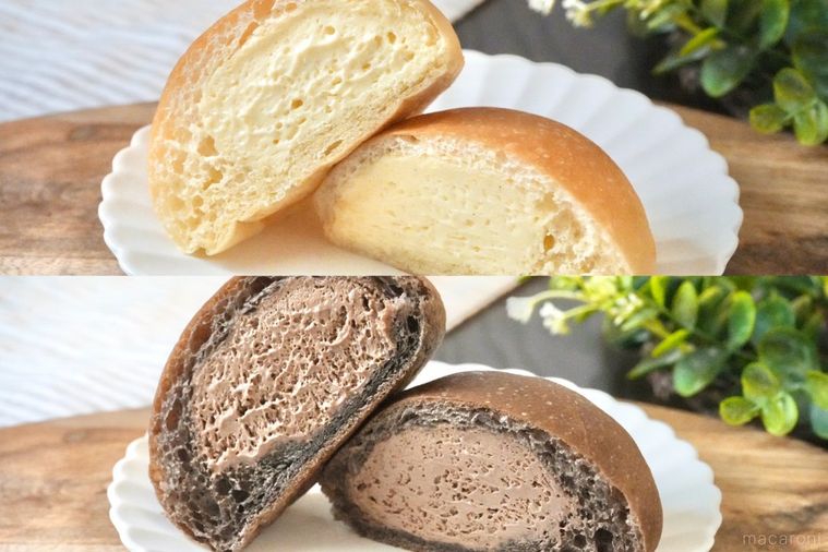 木のカッティングボードと白い皿にのったカスタードホイップとチョコレートの丸いクリームパンの断面とストライプの布とグリーン