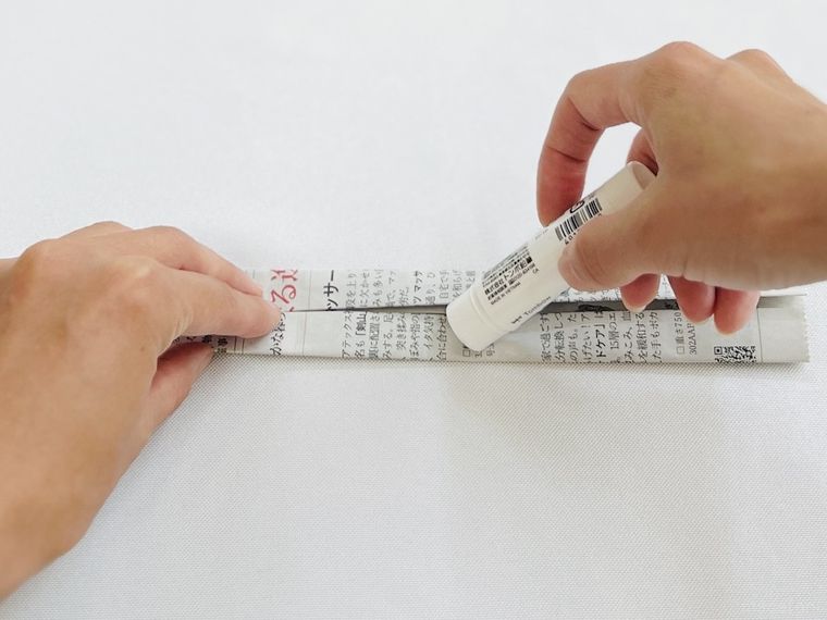 新聞紙にのりを塗っている様子