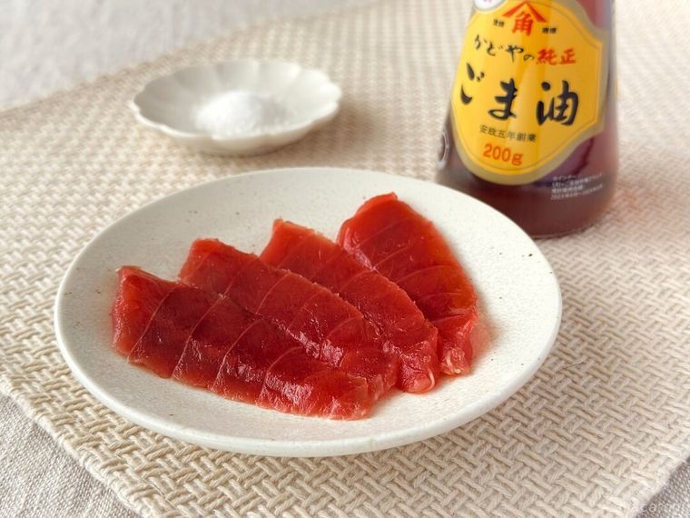 まぐろや金印純正ごま油と塩がテーブルの上に置かれている様子