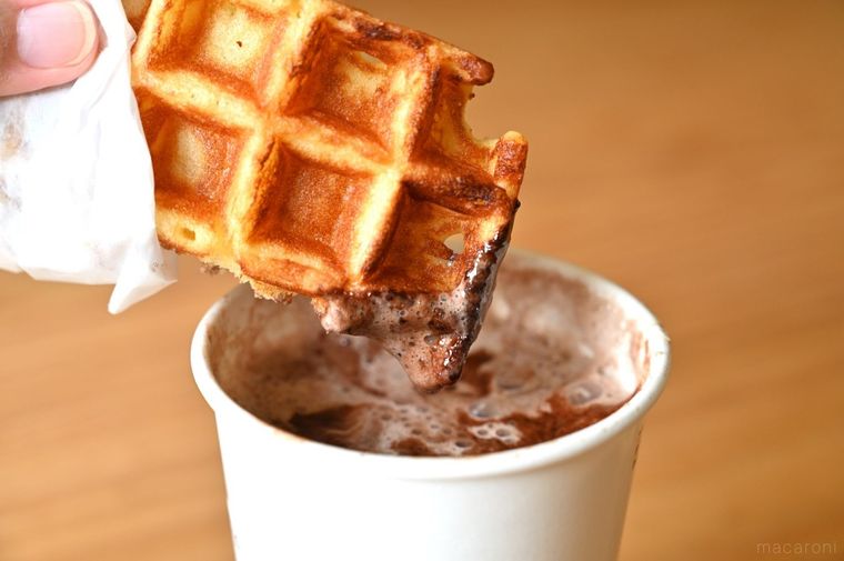 チョコレートドリンクにワッフルをディップしている