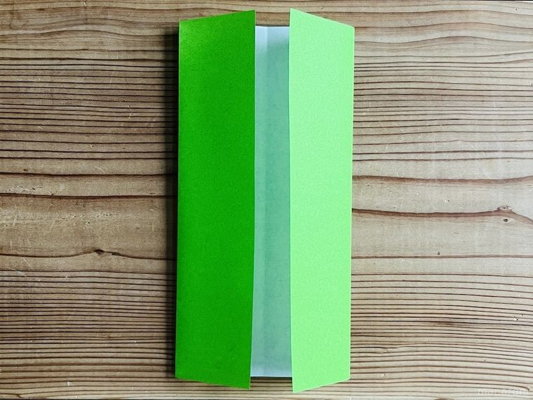 緑色の折り紙を三つ折りにした様子