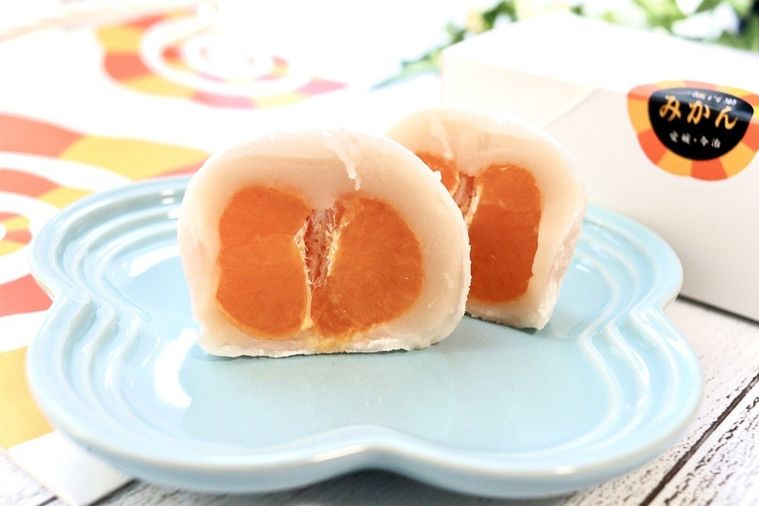 半分に切られたまるごとみかん大福がお皿の上に置かれている