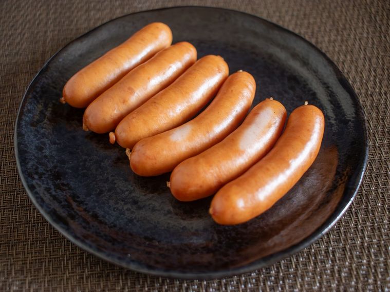 調理後のウインナーを黒い丸皿に盛り付けた様子