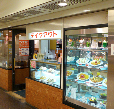 テイクアウトスペースとサンプルが飾られたショーケースがある外観