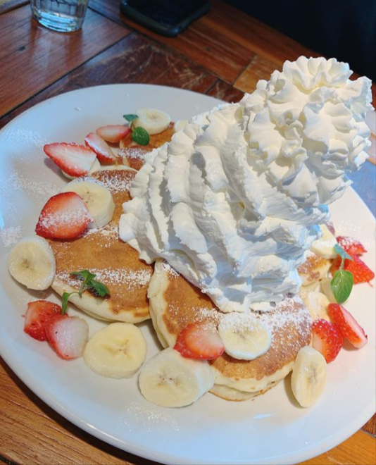 白いお皿に盛られているパンケーキとホイップクリーム