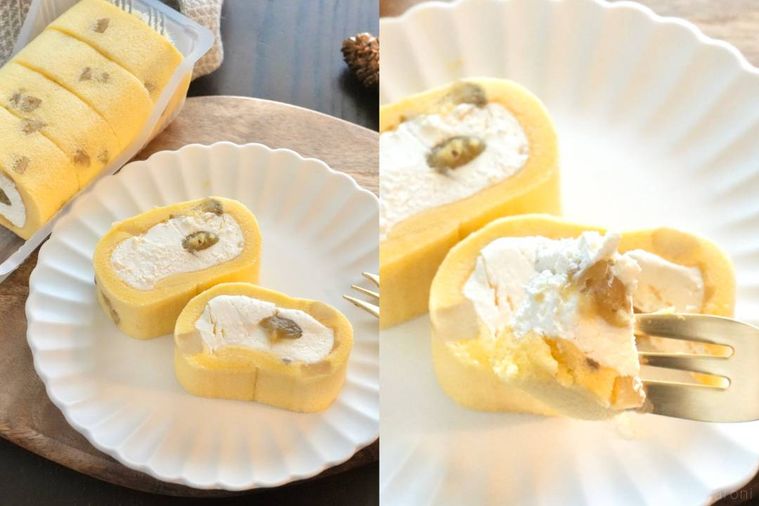 木のカッティングボードと白い皿にのったさつまいものロールケーキを金色のフォークで食べる様子