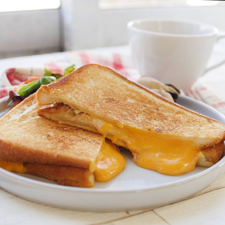 白色の丸皿に盛られたツナチーズホットサンド