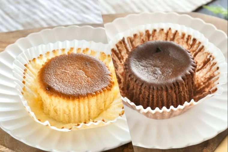 木のカッティングボードと白い皿にのった2種類のベイクドチーズケーキ