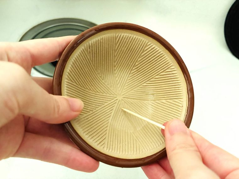 ミニすり鉢の溝を爪楊枝で掃除している