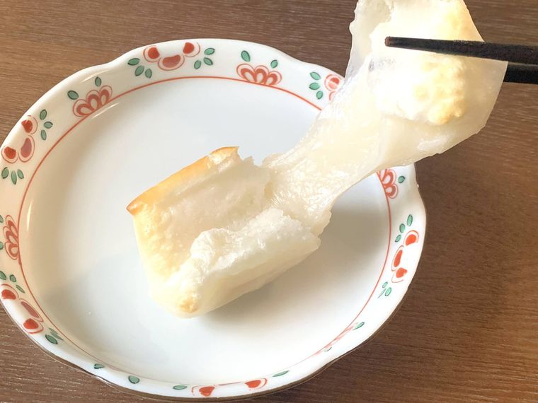 焼いた純 切り餅を箸で持ち上げる様子