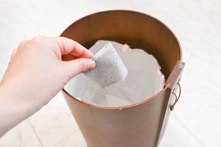 ゴミ箱に水回りの汚れ用 掃除シートを捨てているところ