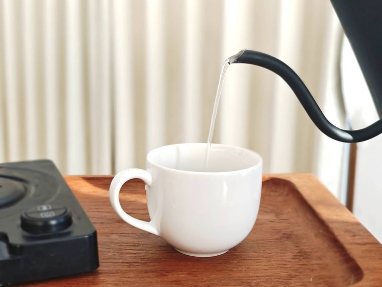 綺麗にした電気ケトルにお湯を沸かし、コップに入れている様子