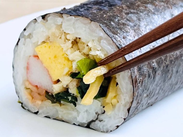 口福恵方巻きに入っている千切り筍煮を箸で引っ張っている様子