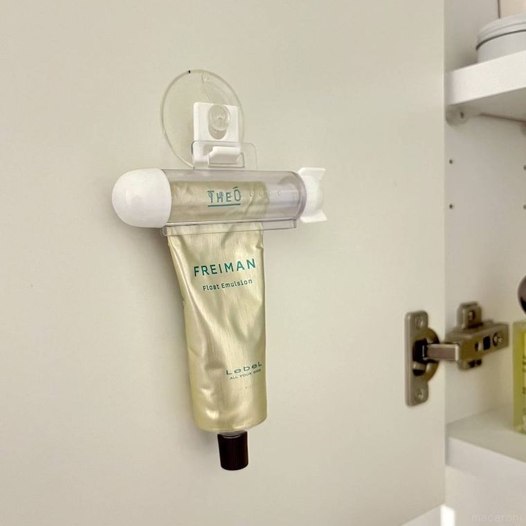 チューブ絞りを吸盤フックで壁に取り付けている