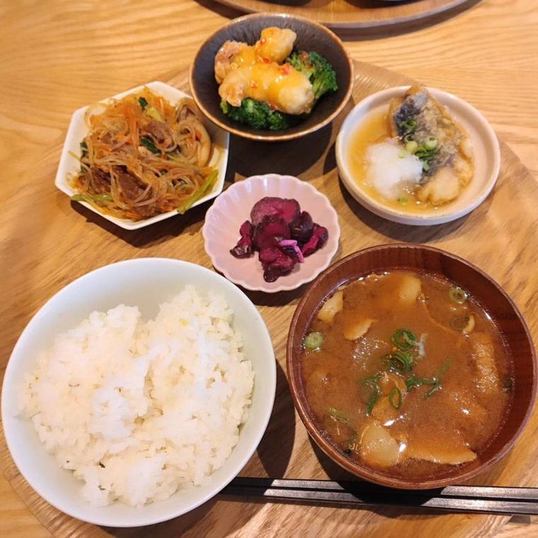 木のトレイにのせられた選べるおかずのデリごはん