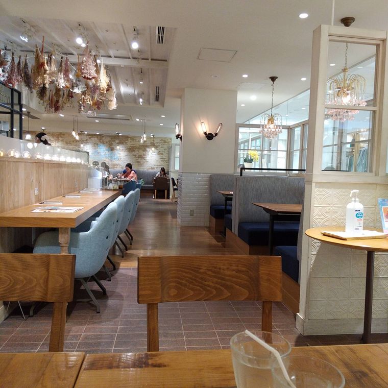 温かみのあるテーブル席が並ぶレストランの内観