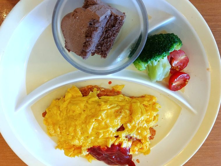 オムライスとチョコレートケーキと野菜がのったお子様プレート
