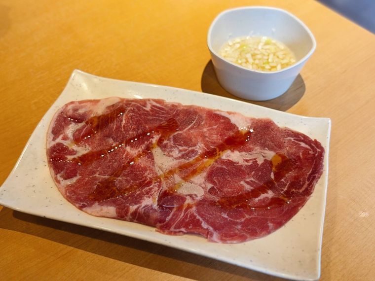 白い器に盛られたロース肉と、ねぎ塩ポン酢