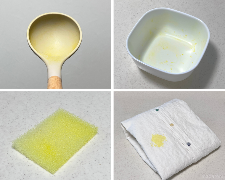 カレーで黄色く染まったお玉、保存容器、食器用スポンジ、白いシャツ
