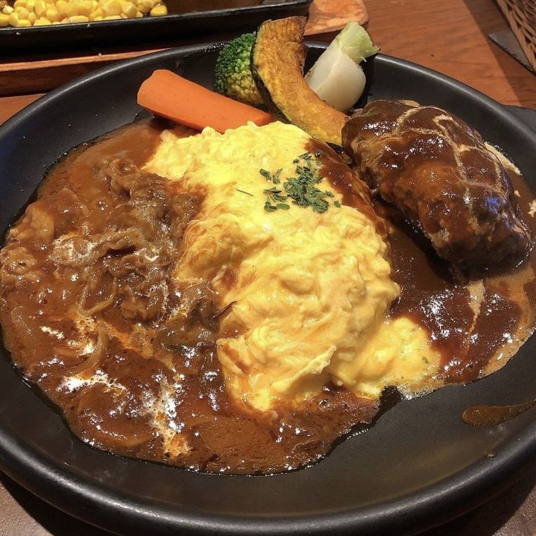 煮込みハンバーグとハッシュドビーフ、オムレツ、グリル野菜がのったランチ