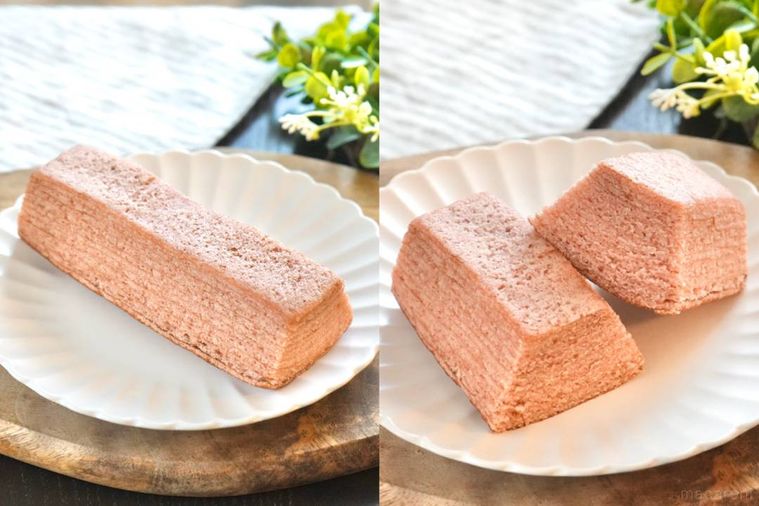 木のカッティングボードと白い皿にのった桜風味のバウムクーヘン