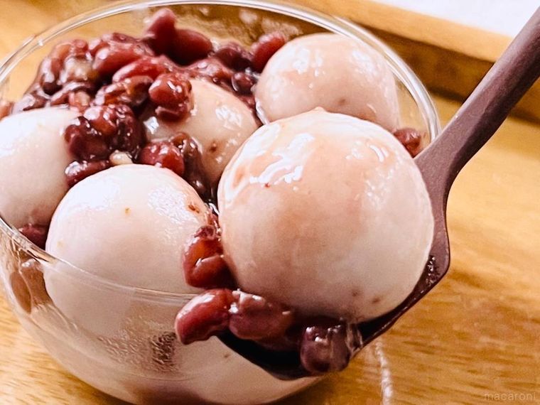 ゆであずきがかかったいちご白玉をスプーンですくった様子