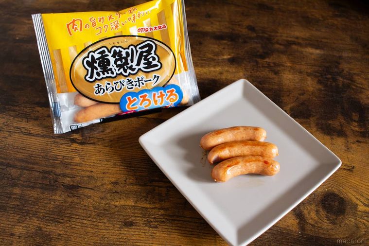 燻製屋 熟成あらびきウインナー とろける濃厚チーズのパッケージと調理したウインナーを盛り付けたお皿が並んでいる