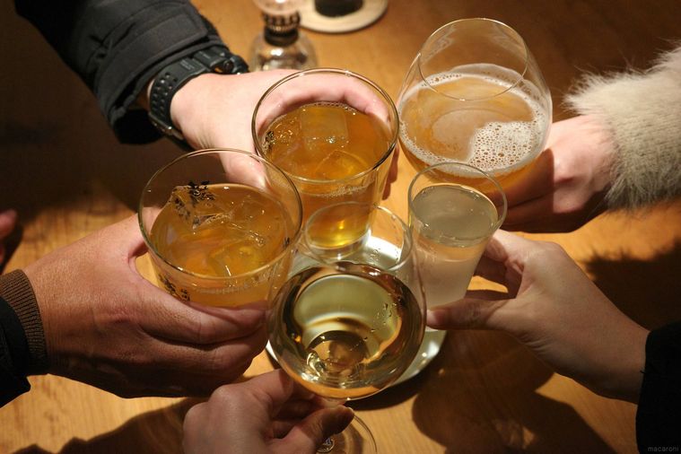 お酒を持って乾杯している様子