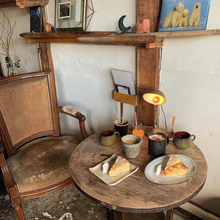 ケーキやコーヒーが並んだ木製のテーブル