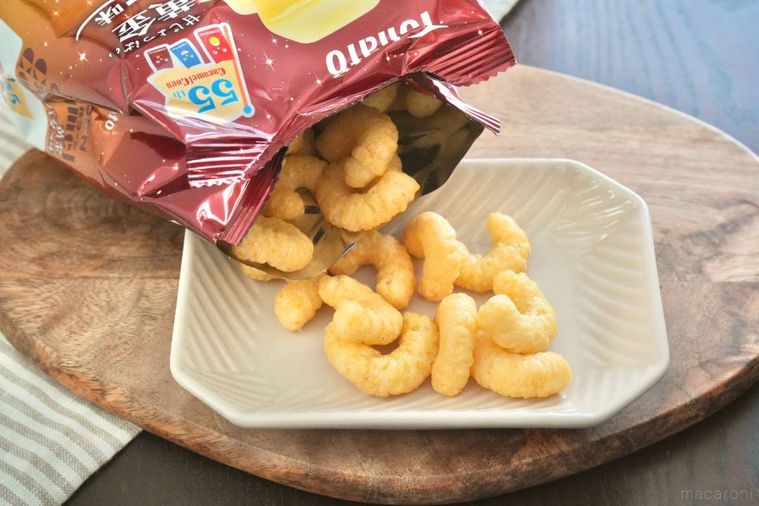 木のカッティングボードと白い小皿にのった黄金バター味のキャラメルコーン