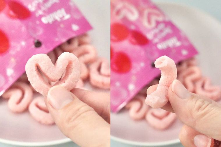 いちごあめ味のピンク色のキャラメルコーンを手に持つ様子