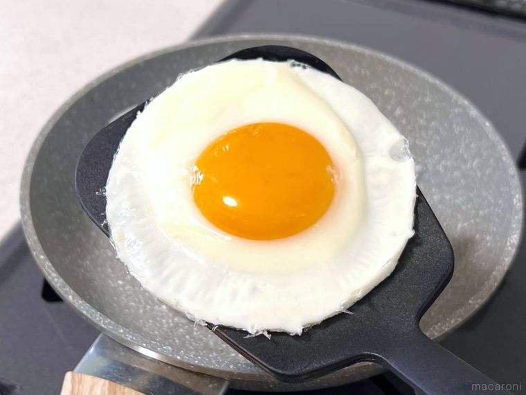 目玉焼きをフライ返しで持ち上げている様子