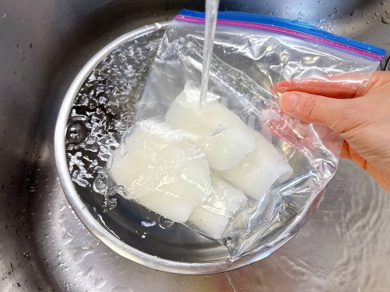冷凍イカを流水解凍する様子