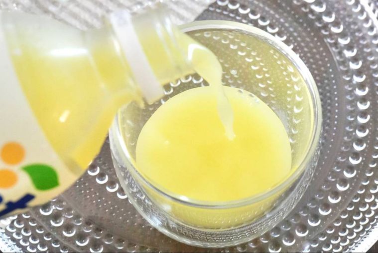 ガラスの器とグラスに黄色い炭酸飲料を注ぐ様子