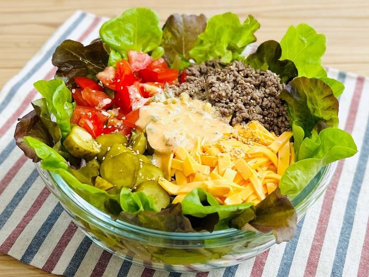 レタス、ひき肉、トマト、ピクルス、チェダーチーズが入ったサラダ