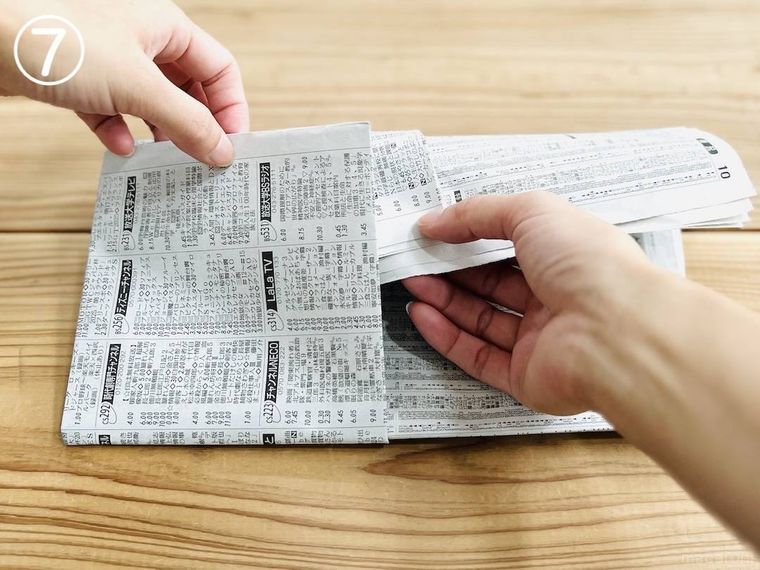 新聞紙でスリッパを作っている様子