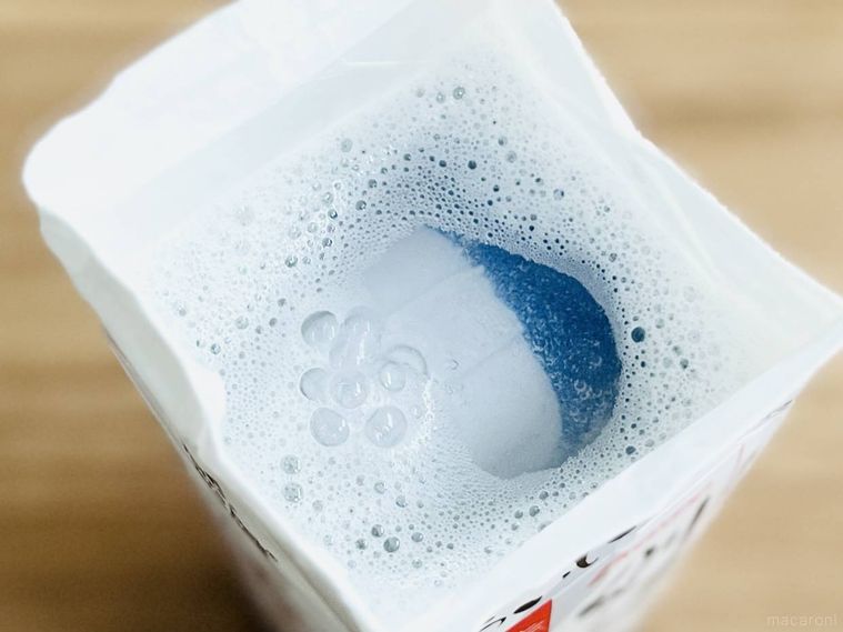 ぬるま湯と洗剤が入った牛乳パックに上履きを沈めた様子