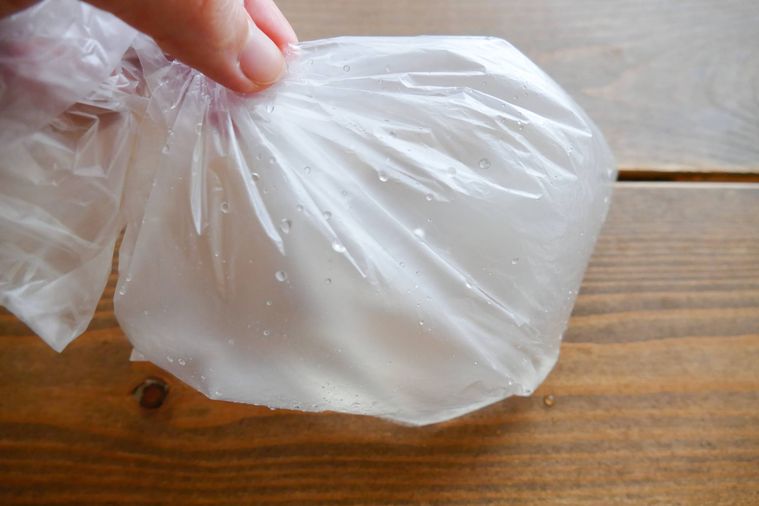 塩糖水を入れた袋を手で持って振る様子