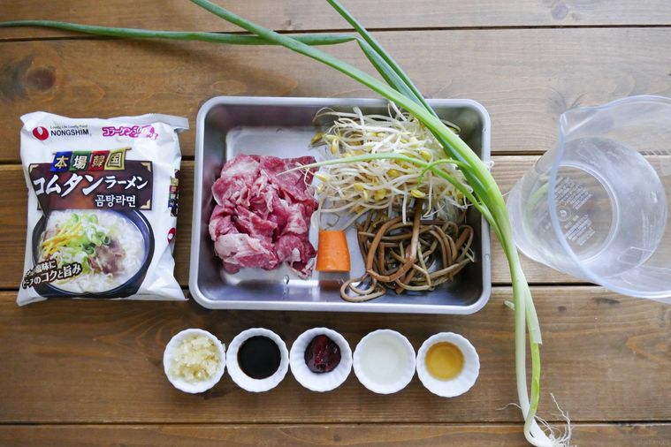 ユッケジャン風コムタンラーメンの材料が並ぶ木製テーブル