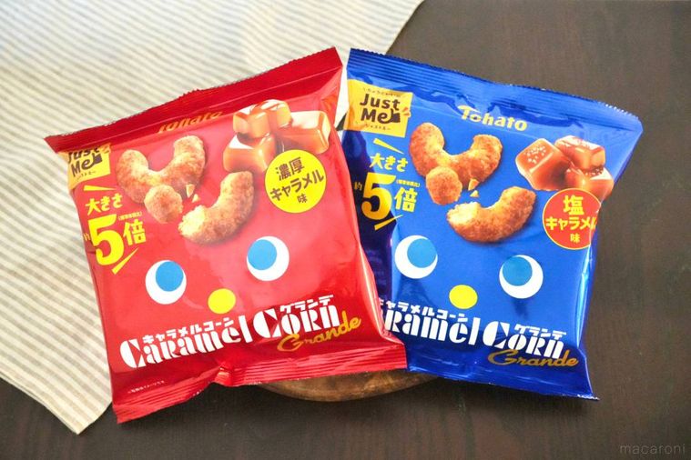 木のカッティングボードにのった赤色と青色のパッケージのキャラメルコーングランデ