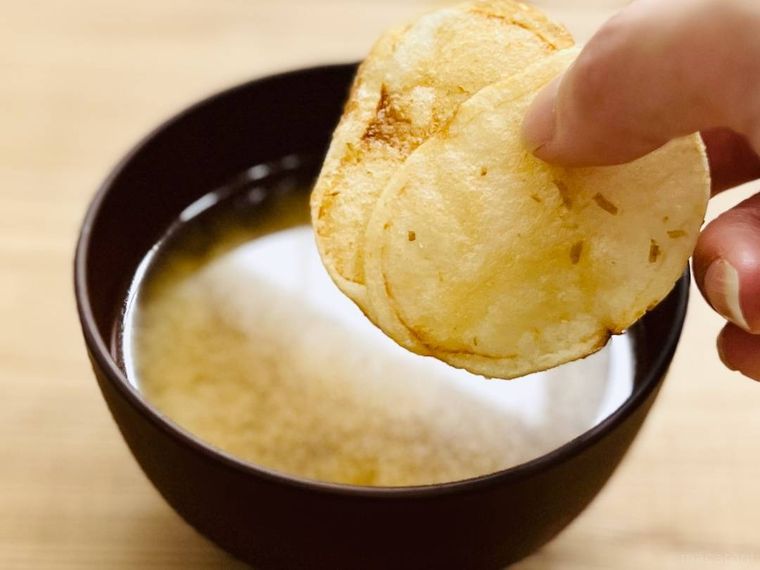 味噌汁にポテトチップスを入れようとしている様子